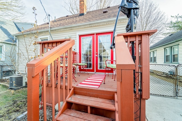 deck featuring french doors, fence, and central AC