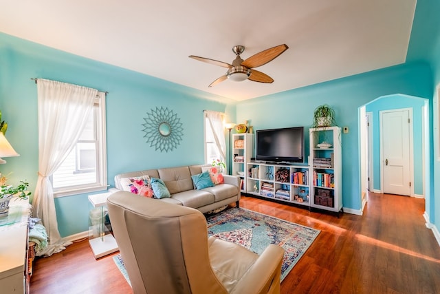 living room featuring a healthy amount of sunlight, wood finished floors, and a ceiling fan