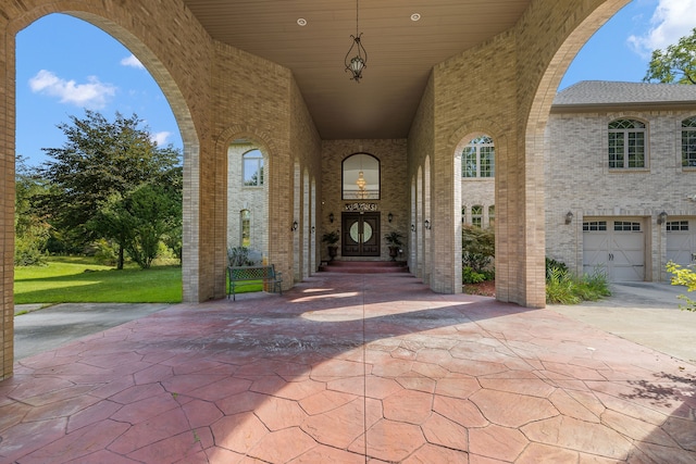 entrance to property featuring brick siding and driveway