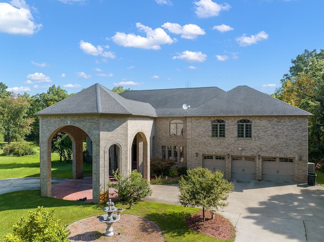 rear view of property featuring a lawn, brick siding, driveway, and a shingled roof