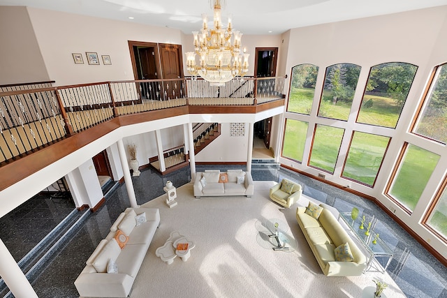 sunken living room with an inviting chandelier, a high ceiling, recessed lighting, and stairway