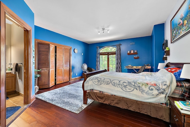 bedroom featuring a closet, baseboards, and wood finished floors