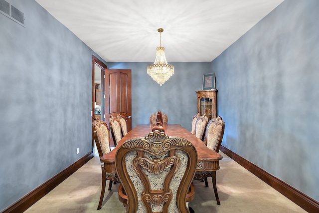 dining space with visible vents, baseboards, and an inviting chandelier