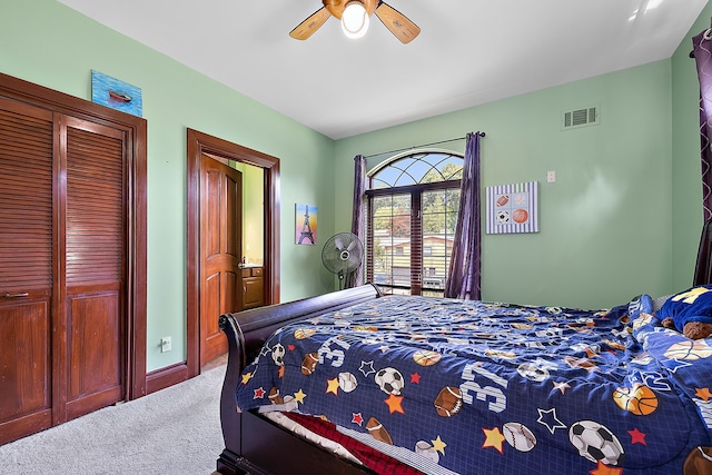 carpeted bedroom with visible vents, baseboards, and a ceiling fan