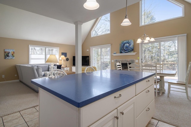 kitchen with light carpet, dark countertops, and plenty of natural light