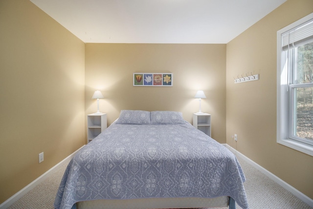 bedroom with carpet and baseboards