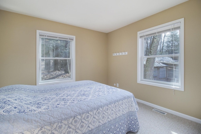 bedroom with carpet, visible vents, and baseboards