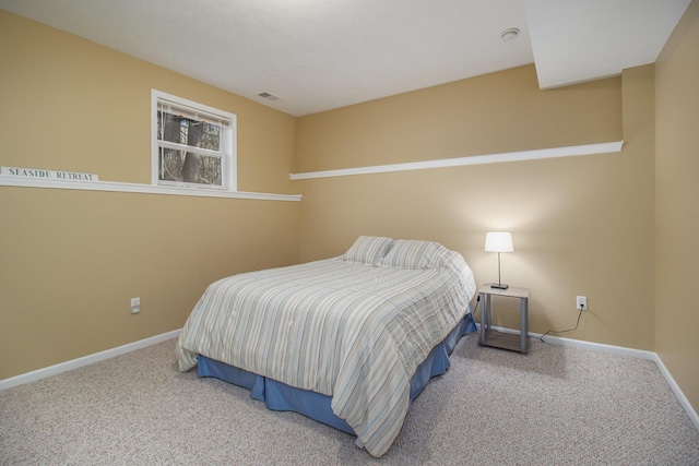 carpeted bedroom with visible vents and baseboards