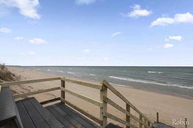 exterior space featuring a water view and a beach view