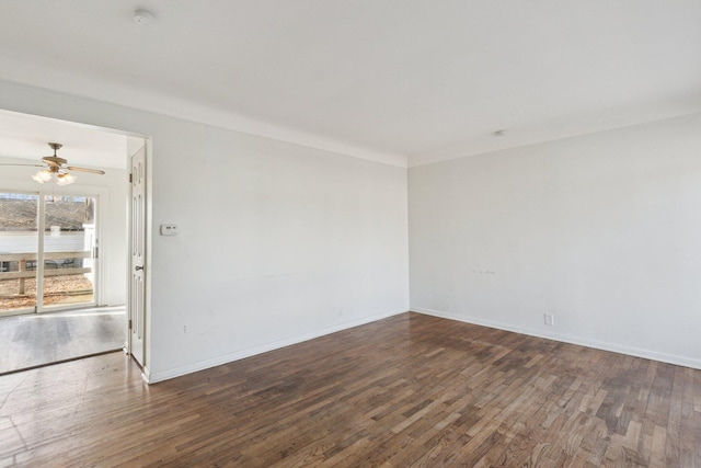 empty room featuring ceiling fan, baseboards, and wood finished floors