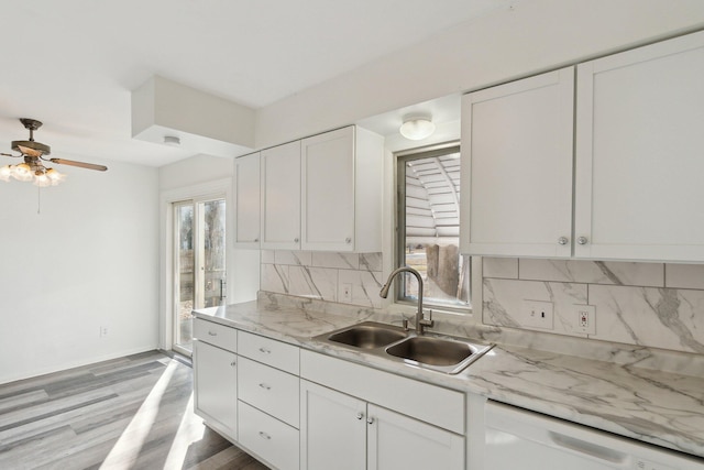 kitchen with dishwasher, a healthy amount of sunlight, tasteful backsplash, and a sink