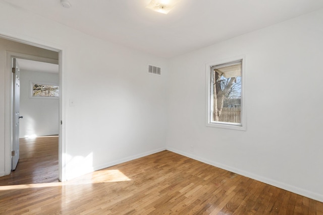 unfurnished room with visible vents, baseboards, and light wood-style floors