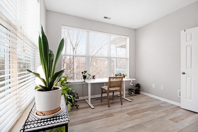 office featuring visible vents, baseboards, and wood finished floors