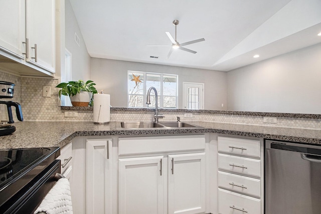 kitchen featuring a sink, vaulted ceiling, white cabinets, dishwasher, and backsplash