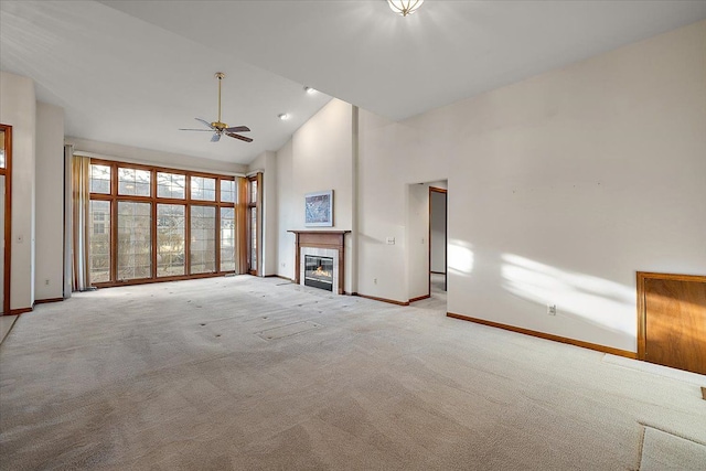 unfurnished living room with baseboards, high vaulted ceiling, and a ceiling fan