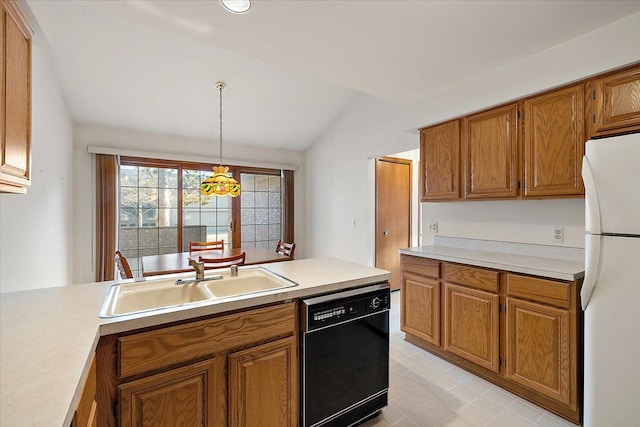 kitchen with black dishwasher, brown cabinets, freestanding refrigerator, and a sink