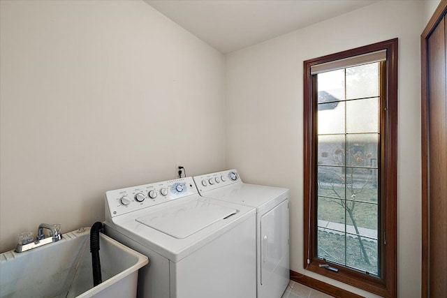 laundry room with a sink, plenty of natural light, separate washer and dryer, and laundry area