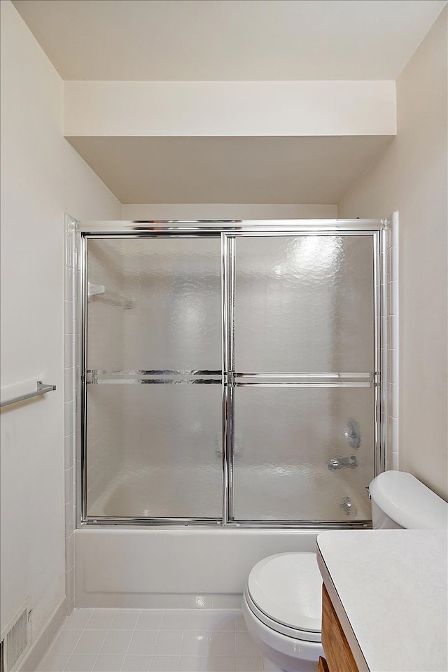 full bath featuring visible vents, toilet, vanity, and bath / shower combo with glass door