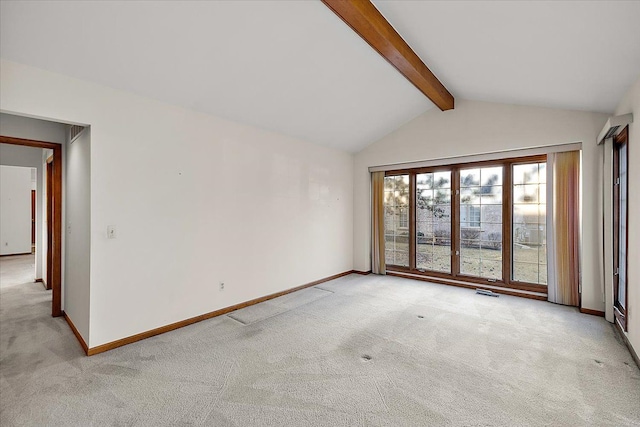 empty room with light carpet, lofted ceiling with beams, and baseboards