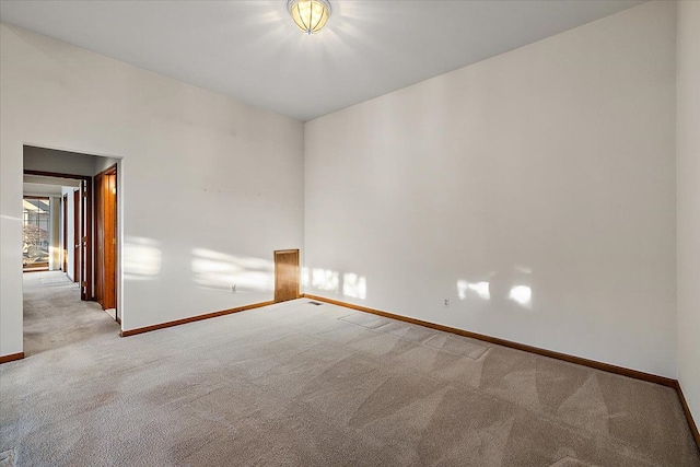 empty room with baseboards and carpet floors