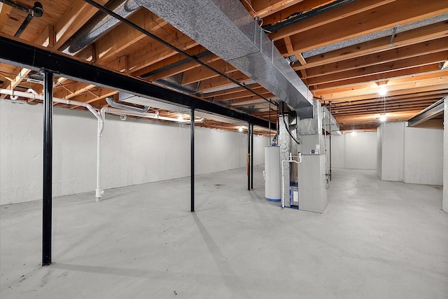 unfinished basement featuring gas water heater and heating unit