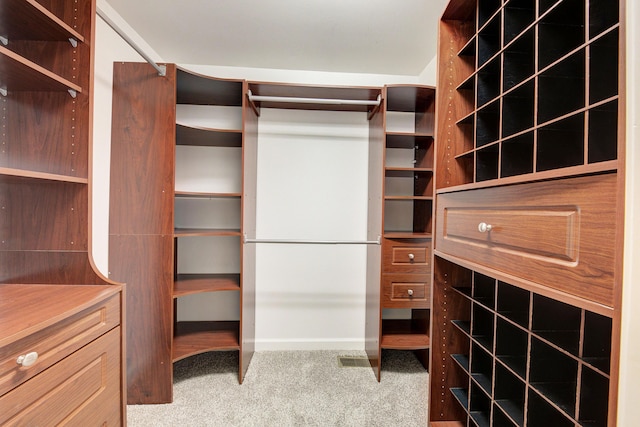 walk in closet with carpet flooring