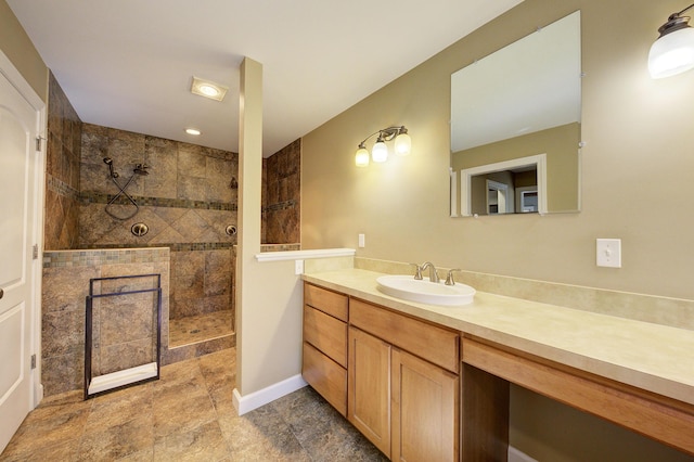 full bath featuring vanity, a walk in shower, and baseboards