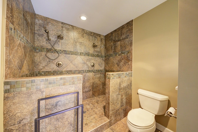 full bathroom with toilet, a walk in shower, and baseboards