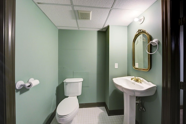 bathroom featuring a drop ceiling, visible vents, baseboards, and toilet