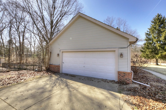 detached garage featuring fence