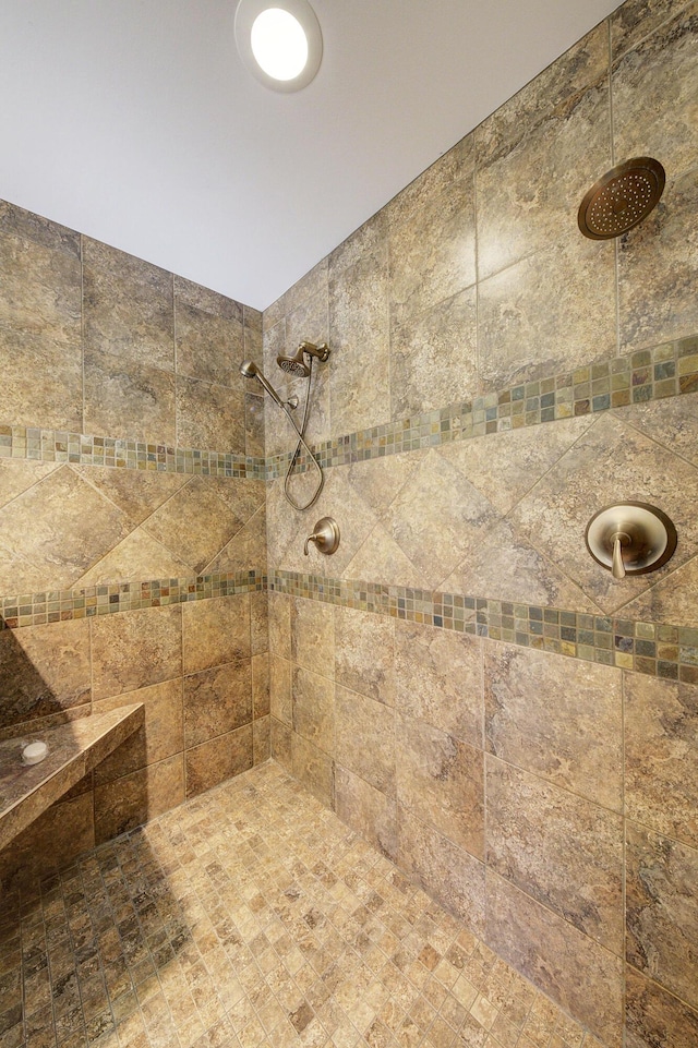 bathroom with a tile shower