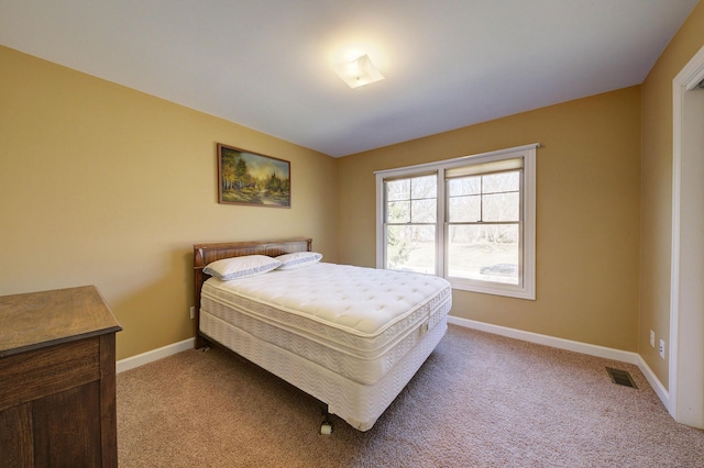 bedroom with light carpet, visible vents, and baseboards