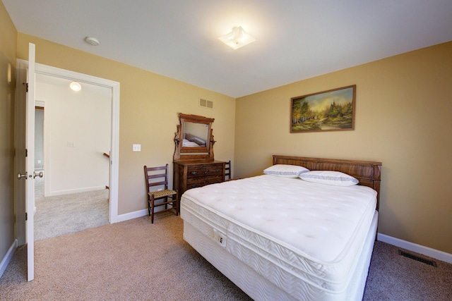 bedroom with visible vents, carpet flooring, and baseboards