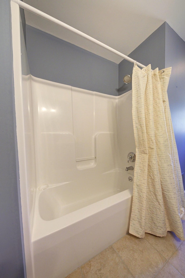 full bathroom featuring tile patterned floors and shower / bathtub combination with curtain