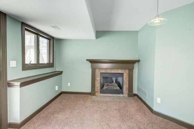 unfurnished living room featuring a fireplace, visible vents, carpet, and baseboards