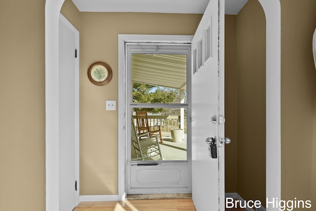 entryway with wood finished floors and baseboards