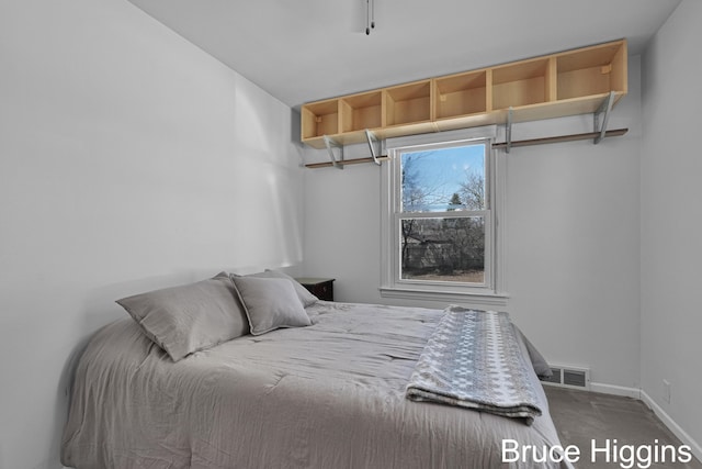 bedroom featuring visible vents, carpet floors, and baseboards