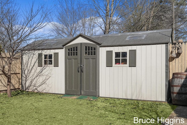 view of shed with fence