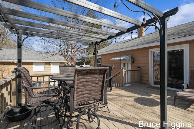 deck with a pergola and outdoor dining area