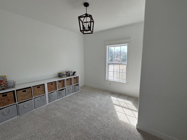 interior space with visible vents, carpet, baseboards, and a chandelier