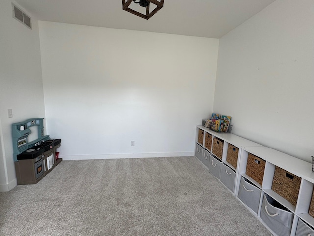 interior space featuring visible vents, baseboards, and carpet