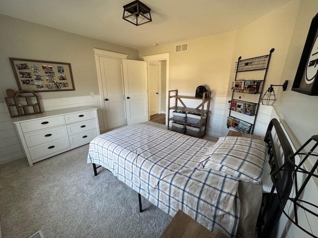 carpeted bedroom featuring visible vents