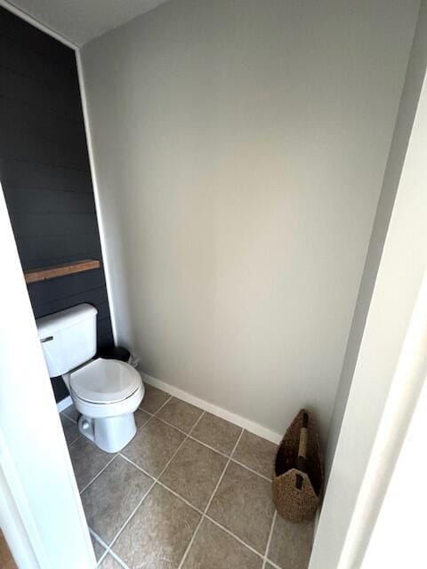 bathroom with tile patterned floors, baseboards, and toilet