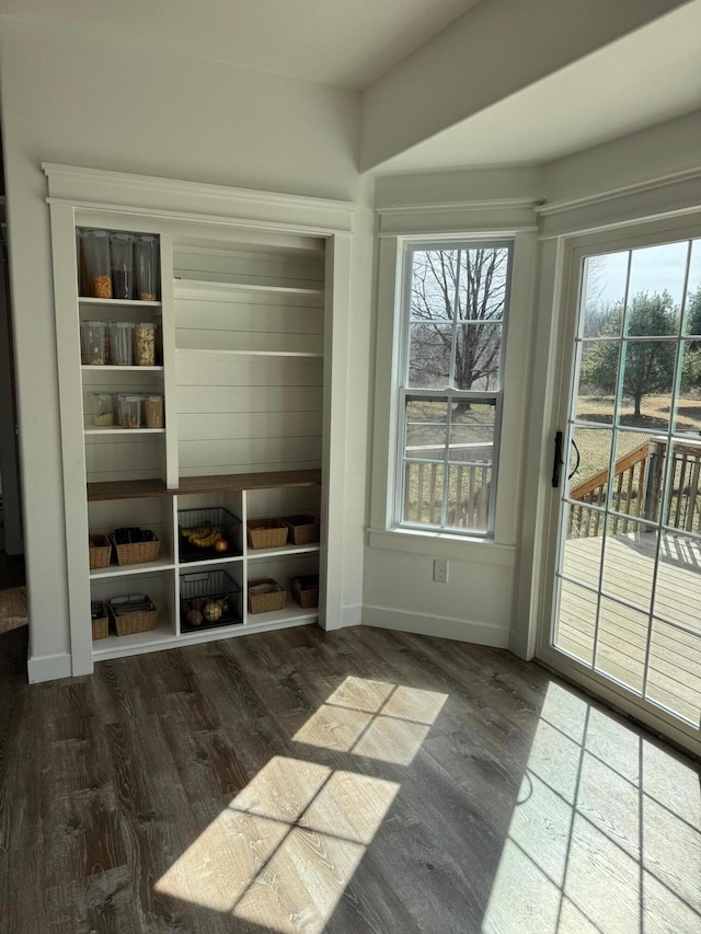 interior space featuring wood finished floors and baseboards