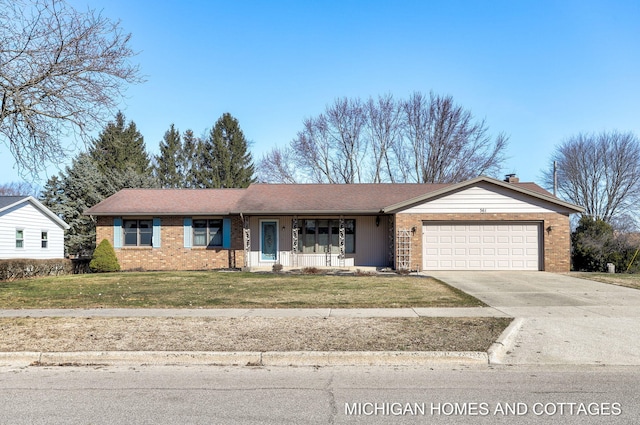 ranch-style home with driveway, brick siding, covered porch, and a front yard