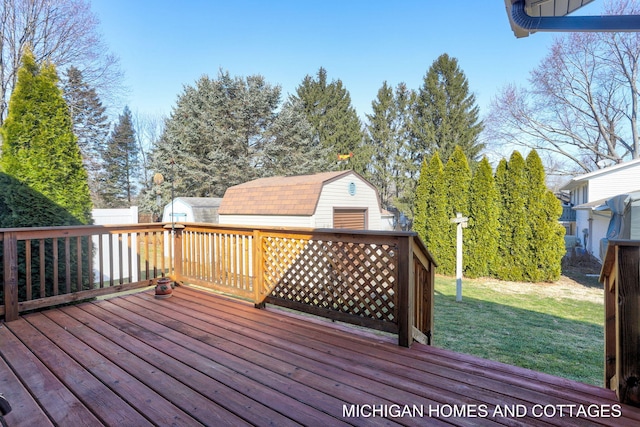 wooden terrace with an outbuilding, a storage unit, a yard, and fence