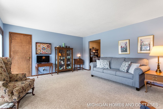 carpeted living room with baseboards