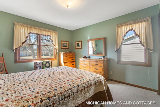 bedroom featuring carpet flooring, multiple windows, and baseboards