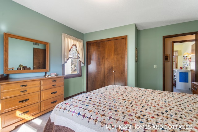 carpeted bedroom with a closet and visible vents