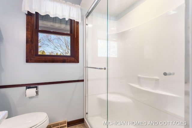 bathroom featuring visible vents, a shower stall, and toilet